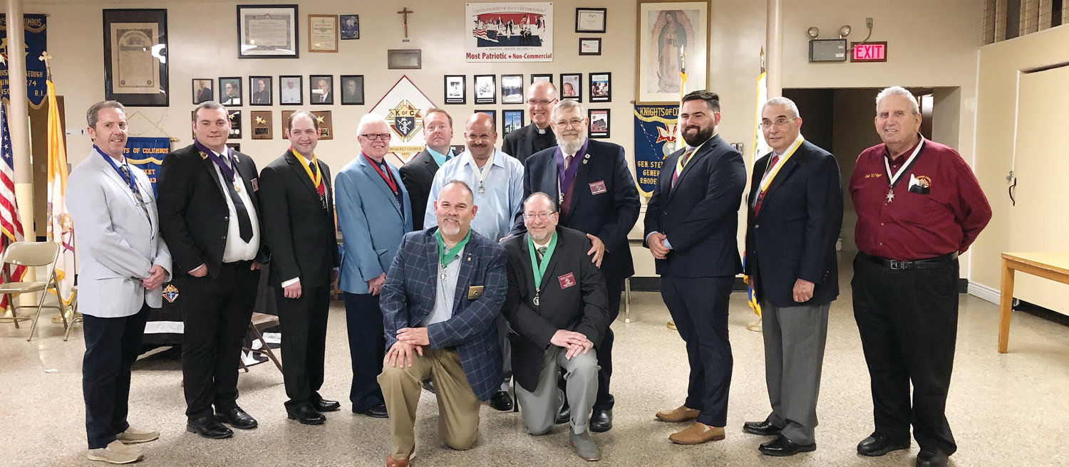 Woonsocket Knights Council 113 Installs New Officers: The Woonsocket Council 113 Knights of Columbus recently held its installation of officers for the fiscal year of 2019 – 2020.  Standing in the back row are William Desrosiers (Treasurer), Jonathan Taft (Deputy Grand Night), Matthew Belair (Advocate), Joseph Crisafully Sr. (Warden), Craig Lacouture (Lecturer), Marc Pare (Inside Guard), Father Michael Kelley (Chaplain), Paul Bourget (Grand Knight), Andrew Gaulin (Financial Secretary), Donald Hoard (Recorder), and Ovide Auger (Chancellor).  Kneeling in the front row are Jeffrey Gaulin (One Year Trustee) and John Tracy 3rd (Three Year Trustee and Immediate Past Grand Knight). Not pictured are Christopher Hoard (Outside Guard) and Eugene Garceau (Two Year Trustee).